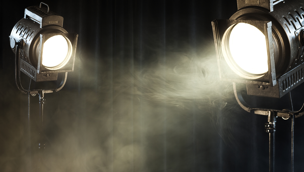 Theater,Spot,Lights,On,Black,Curtain,With,Smoke