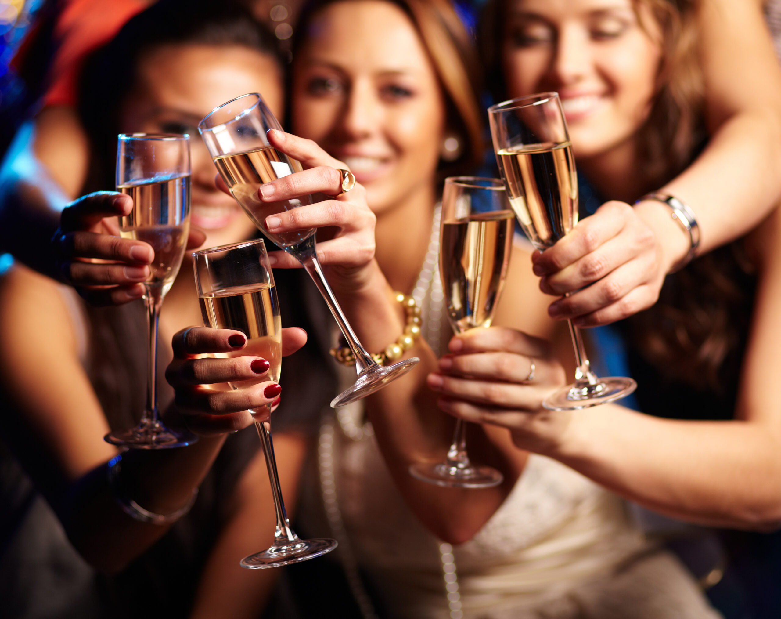 Group,Of,Partying,Girls,Clinking,Flutes,With,Sparkling,Wine